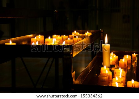 row of candles in Frauenkirche (Cathedral of Our Dear Lady), Munich, Germany