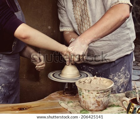 Woman creating a bowl on a Potter\'s wheel, the master class of pottery art