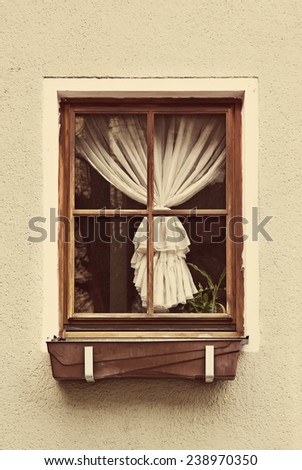 Vintage wooden window frame with curtain in the old house