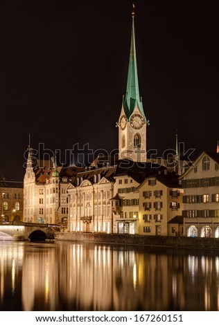 Zurich, Switzerland. The Lady Minster cathedral and the Limmat river in the evening.