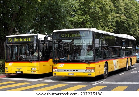 Lucerne, Switzerland - 14 July, 2015: two buses waiting for the green traffic light. Lucerne is a city in central Switzerland, it is the capital of the Canton of Lucerne.
