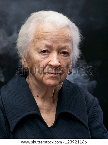 Portrait of old woman on a gray background