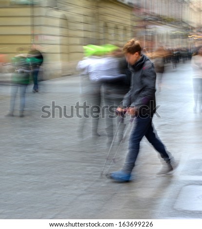 Injured young man on crutches,  intentional motion blur