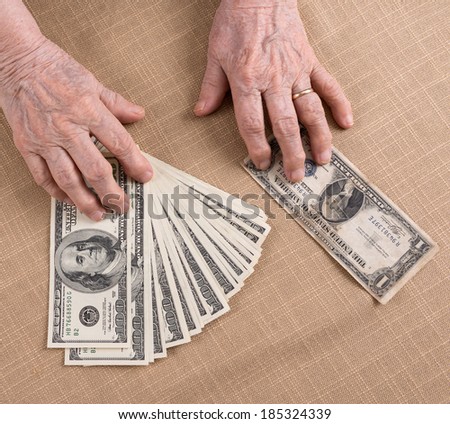 Old woman's hands and dollar bills