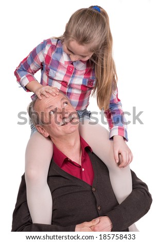 Portrait of a little girl enjoying piggyback ride with her grandfather on a white background