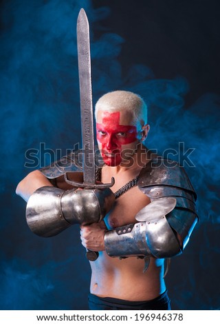 Knight with a sword on a blue smoky background