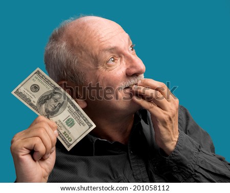 Lucky old man holding dollar bill on a blue background