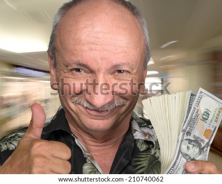 Lucky old man holding dollar bills at business center