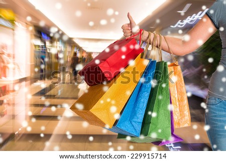 Woman holding shopping bags at shopping mall.  Christmas and holidays concept
