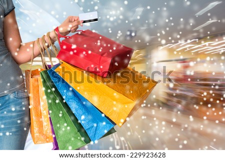 Female holding shopping bags at shopping mall.  Christmas and holidays concept