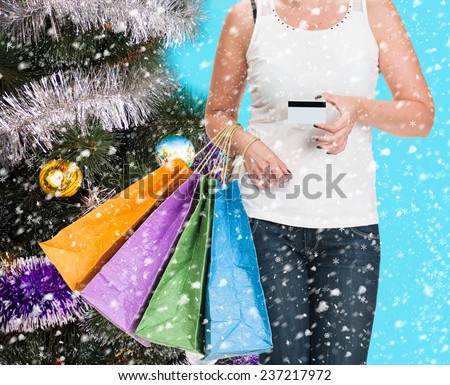 Female holding shopping bags at shopping mall. Christmas and holidays concept