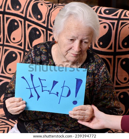 Old woman holding help billboard