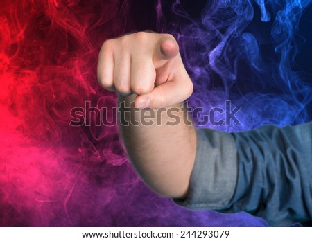 Man pointing out towards you against smoky background