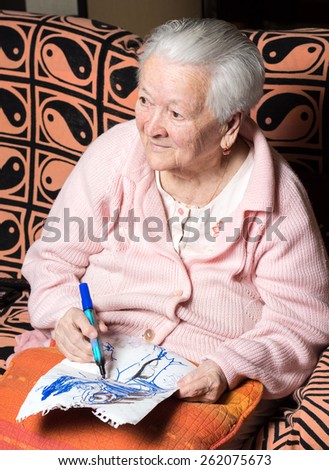 Old woman painting for fun at home