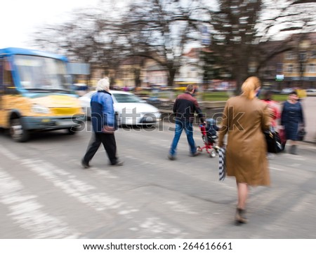 Busy city street people on zebra crossing. Intentional motion blur