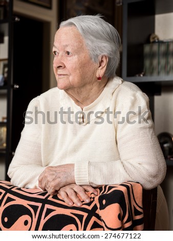 Portrait of old woman at home