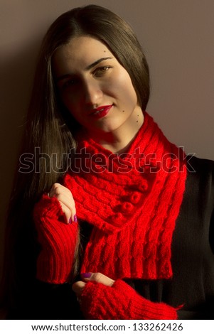 Beauty girl portrait, young fresh woman, face.  Shade from the sun falls on the face, a red scarf and gloves, ready for winter.