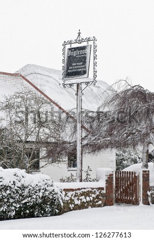 PAGHAM, WEST SUSSEX, ENGLAND JANUARY 18: Pub sign is covered in snow on January 18 2013 in Pagham. The first proper snow fall of the year covers much of the south east of England.