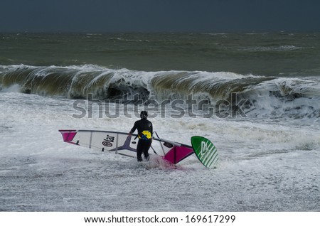 PAGHAM, WEST SUSSEX, ENGLAND -Â?Â? JANUARY 4: A wind surfer has been pushed ashore in high waves on January 4, 2014. High waves threaten to flood homes and towns as storms batter the UK's coastline.