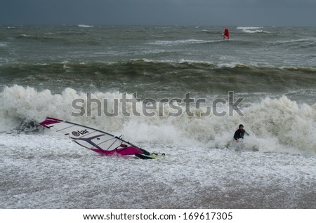 PAGHAM, WEST SUSSEX, ENGLAND -Â?Â? JANUARY 4: A wind surfer has been pushed ashore in high waves on January 4, 2014. High waves threaten to flood homes and towns as storms batter the UK\'s coastline.
