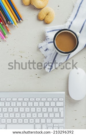 Office Desk with keyboard, mouse, coffee, cookie and crayon