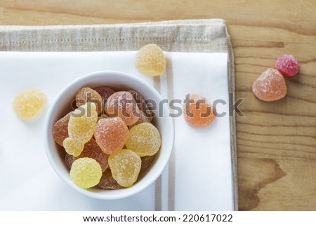 Gummy candies on wooden background