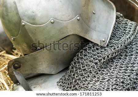 Silver metal helmet and vest as armor protection in medieval tournament