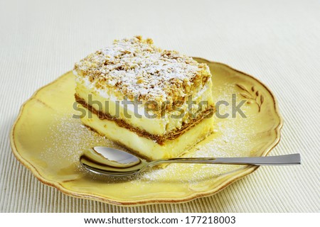 Napoleon - vanilla and custard cream cake with whipped cream and dusting.
