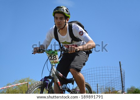 CLUJ-NAPOCA, ROMANIA - APRIL 27, 2014: Unidentified mail rider races on mountain bike at \