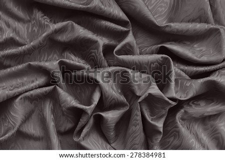 Brown silk damask fabric with wavy pattern. Wavy textured background.