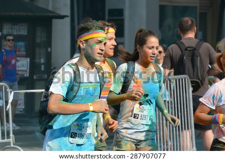 CLUJ-NAPOCA, ROMANIA - JUNE 13, 2015: Group of unidentified runners painted in all colors have fun at the public event The Color Run.