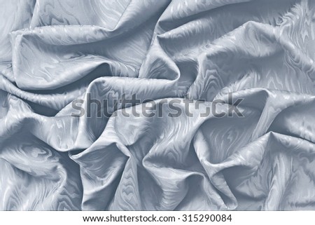 Silver silk damask fabric wavy texture background.