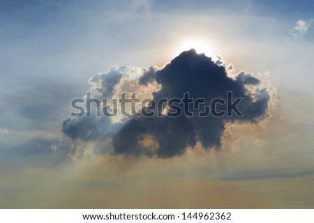 Sun and lens flare Behind clouds with blue sky