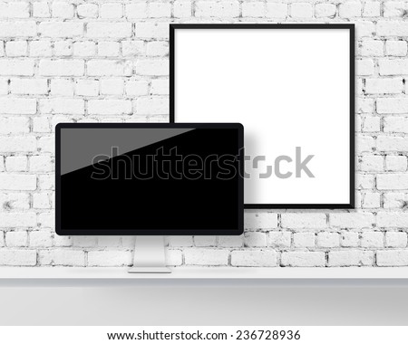 Display on a table and blank picture frame on a brick wall
