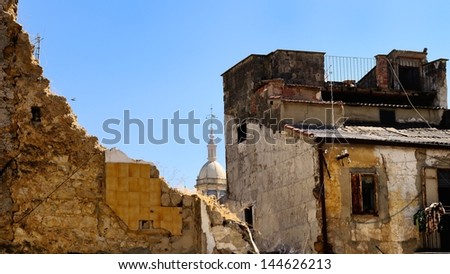 S.Sebastiano church\' dome behind old and crumbling buildings, Caltanissetta. Sicily, Italy