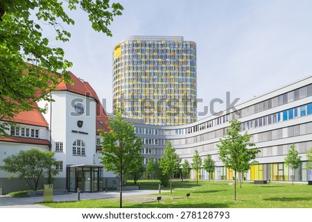 Munich, Germany - May 12, 2015: Old small clubhouse and the new ADAC Headquarters with 18-story office tower rises above a 5-storey base which accommodates 2,400 employees.