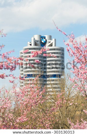 Munich, Germany - April 12, 2015: BMW headquarters high-rise tower office building in spring blossoming Olympiapark.