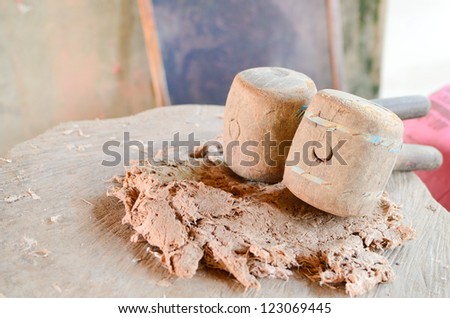 Old wooden mallet on the bark