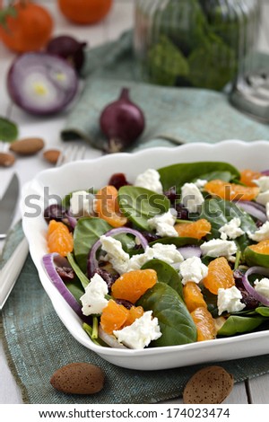 Baby spinach salad with tangerines, almonds, dried cranberries and feta cheese.