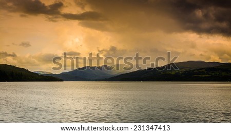 A unique moody/stormy view across Lake Windermere on the edge of a dark storm with dark/contrasting lighting