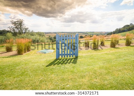 A closed gate in an open field. Could be used as, thinking outside the box, around a problem, psychology, careers, retirement, etc..