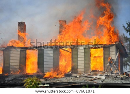 residential home on fire, fully involved, engulfed in orange fire and flames, concept disaster
