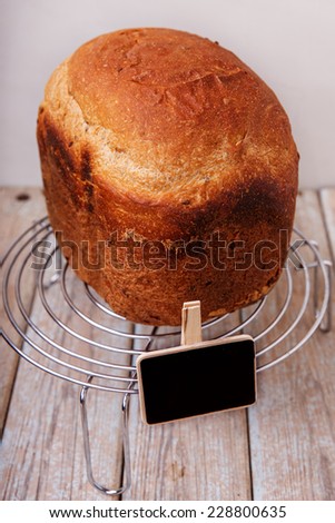Homemade bread on the grid-patterned  (with a card for the label), top view