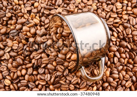 Glass cup of coffee filled up with beans