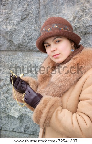 Woman in coat with vintage watch
