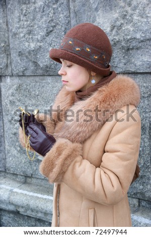 Woman in coat with vintage watch