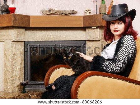 Young woman with cat near fireplace