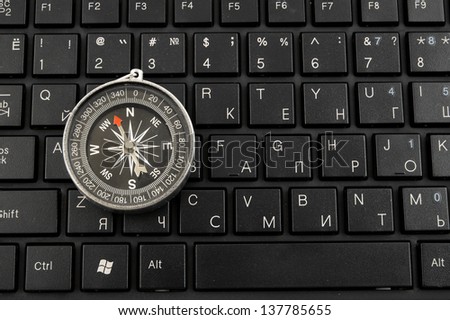 Computer keyboard and compass, internet navigation concept