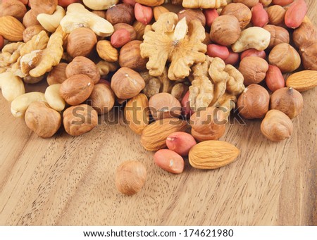 Mixed nuts on wooden background