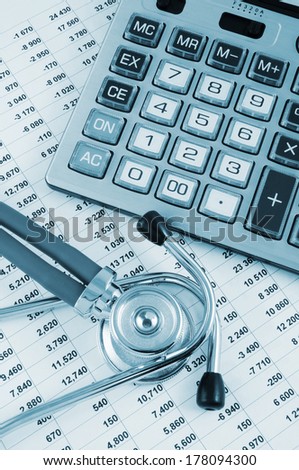 Cost of health care concept, stethoscope and calculator on document
